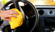 Steering Wheel being Cleaned in Car